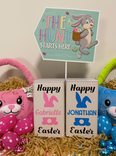 Load image into Gallery viewer, Photo of 2 personalised ivory tin canister with Happy Easter and a picture of a pink bunny on one and a blue bunny on the other