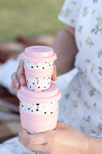 Load image into Gallery viewer, A person holding two stacked cups, one big, one smaller, with pink lids and polka dot patterns that say "live laugh label." The background is softly blurred.